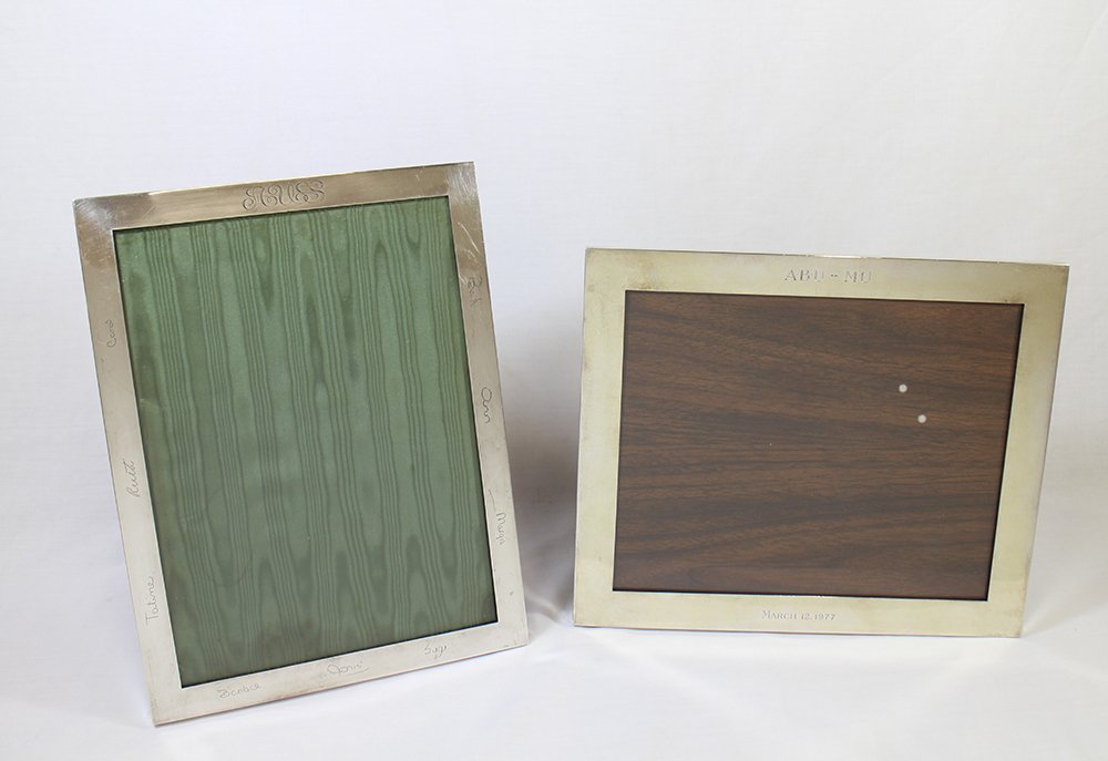 (2) STERLING SILVER PICTURE FRAMES: Cartier & Dominick & Haff sterling silver picture frames. Cartier 12" x 10" and Dominick & Haff 12 1/4" x 9 1/2." Both are monogrammed. Some indentations & scratches.