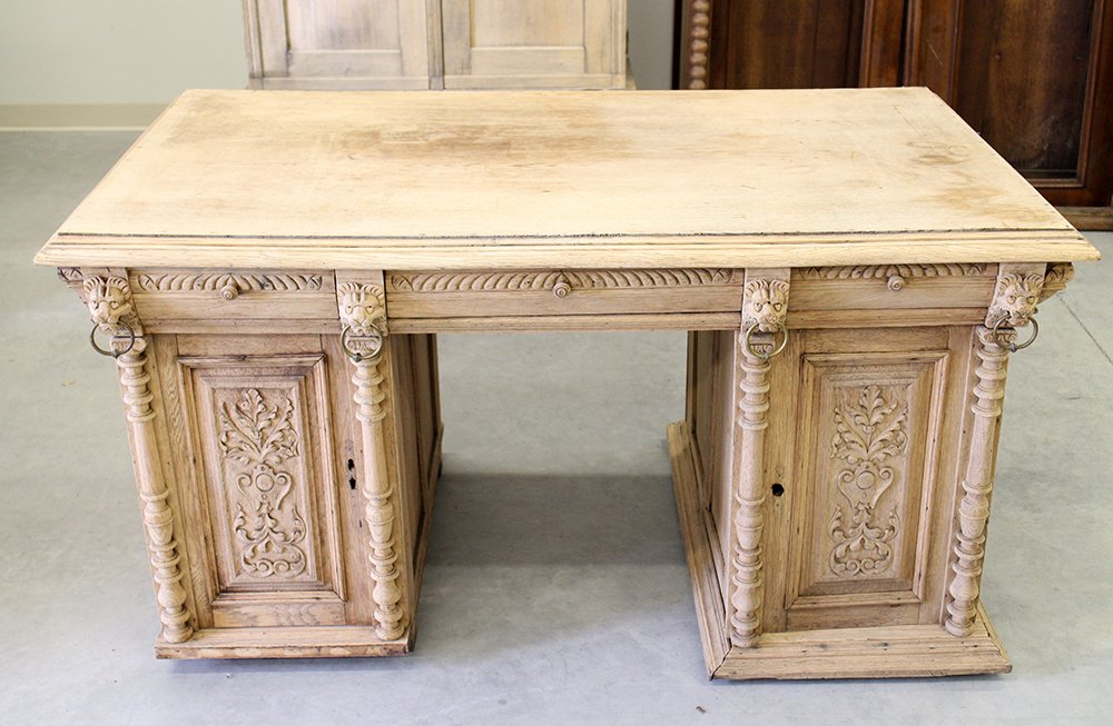 ANTIQUE PARTNER'S DESK: Antique partner's desk with lion head accents. Some doors/parts not attached. Desk is striped and needs some restoration. Measures 59" x 35 1/2" wide 31" tall.
