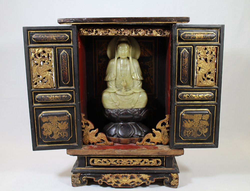 CHINESE WOOD SHRINE: Chinese double door wood shrine with carved soapstone figurine. Chip to top of figurine. Shrine measures 16 1/4" x 11 1/4" x 5 1/2"