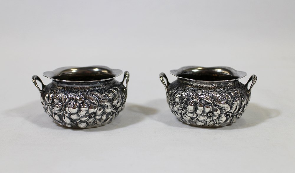 (2) HOWARD & CO STERLING SALT CELLARS: Pair of Howard & Co sterling silver open salt cellars with flower repousse. 2 1/2" wide. Weighs 2.76 OZT.