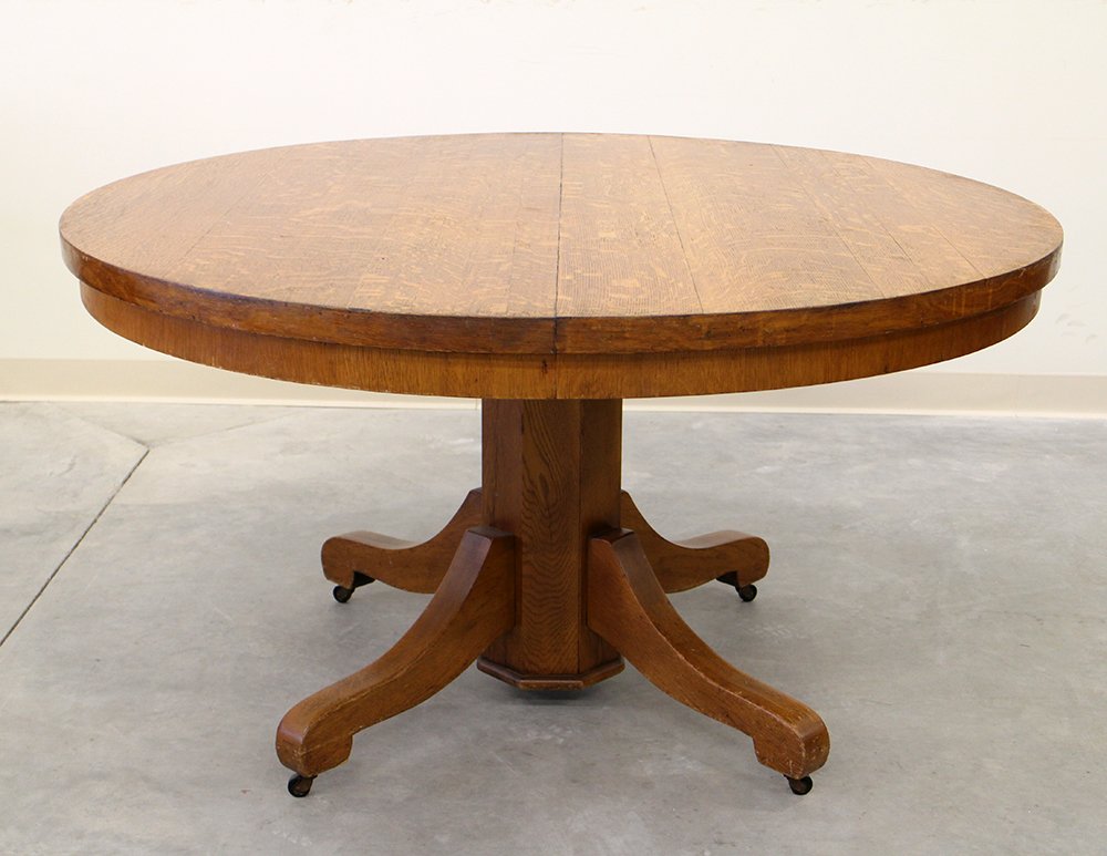 ROUND OAK DINING TABLE: Oak table with tiger stripe design. Measures 29 3/4" tall 54" wide. Cooper Wells & Co Iron Clad label.