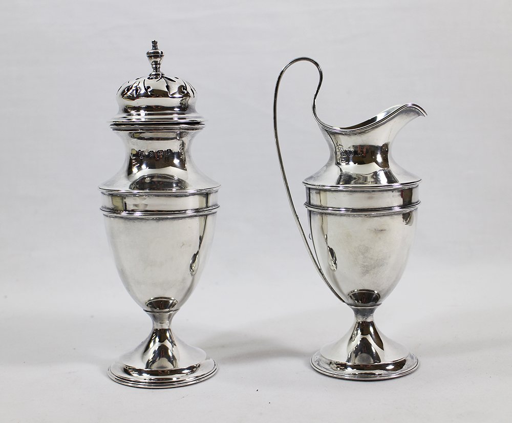 ENGLISH STERLING CREAMER & SUGAR SHAKER: English hallmarked sterling silver creamer (London, Philip Hanson Abbot (?) silversmith, unknown year) 6 1/4" tall to handle and sugar shaker (Birmingham, 1908, TAE silversmith) 6 1/2" tall. 8.66 OZT.
