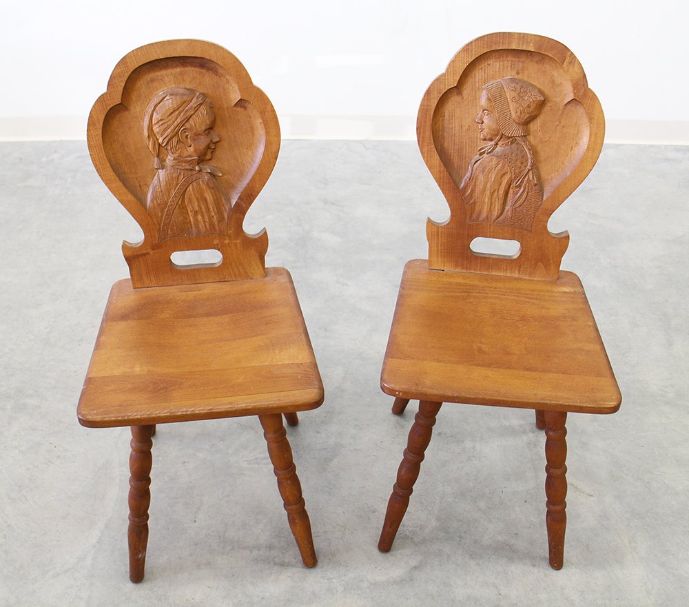 (2) GERMAN PORTRAIT CHAIRS: Pair of German Black Forest carved wood portrait chairs. 35 1/2" tall 15 1/2" wide.
