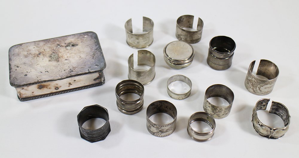 SILVERPLATE BOX & NAPKIN RINGS: Silverplate box with lion insignia and assorted silverplate napkin rings - most rings were cut to make bracelets.