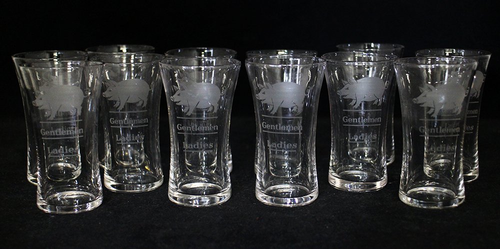 12 ETCHED PIG LADIES GENTLEMEN SHOT GLASSES -1920s: Collection of prohibition era whiskey shot glasses. There is an etched pig / hog with lines for Ladies and Gentlemen. The measure 3" tall.