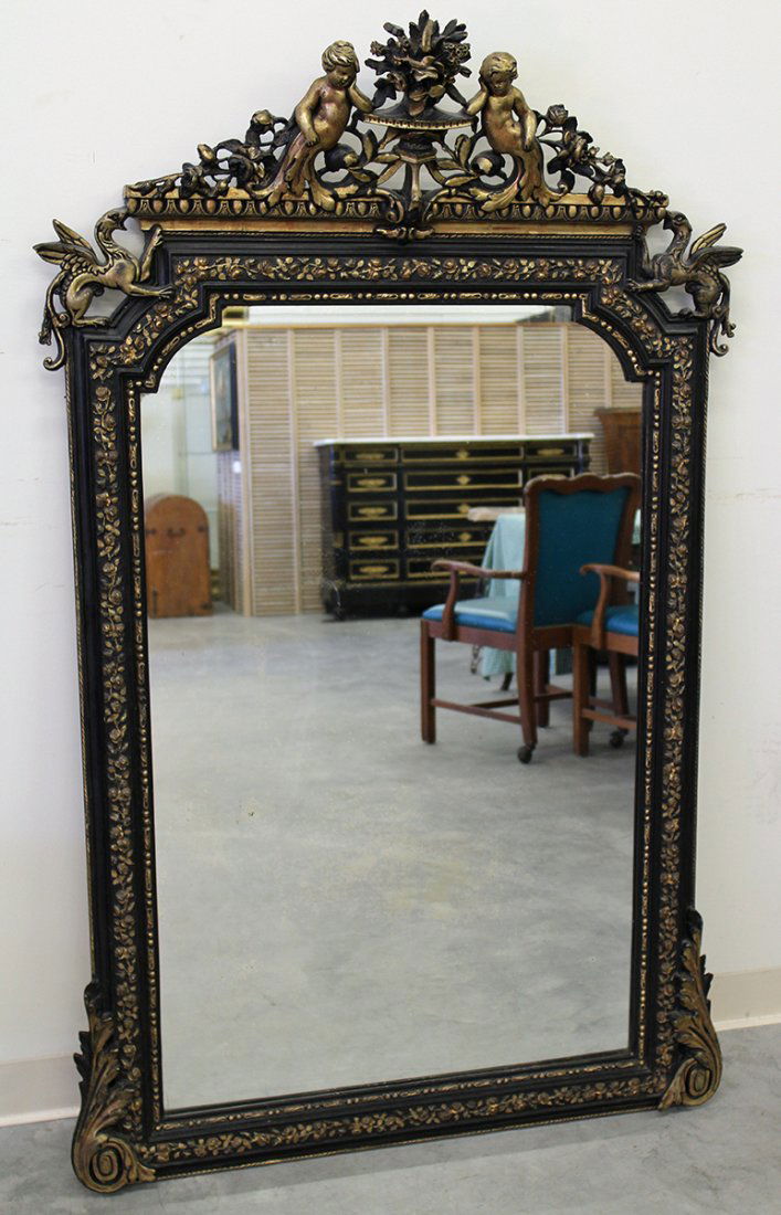 19TH CENT. FRENCH CHERUB & GRIFFIN MIRROR: Gold & ebony mirror with cherub & griffin accents. 58" tall 37 1/2" wide.