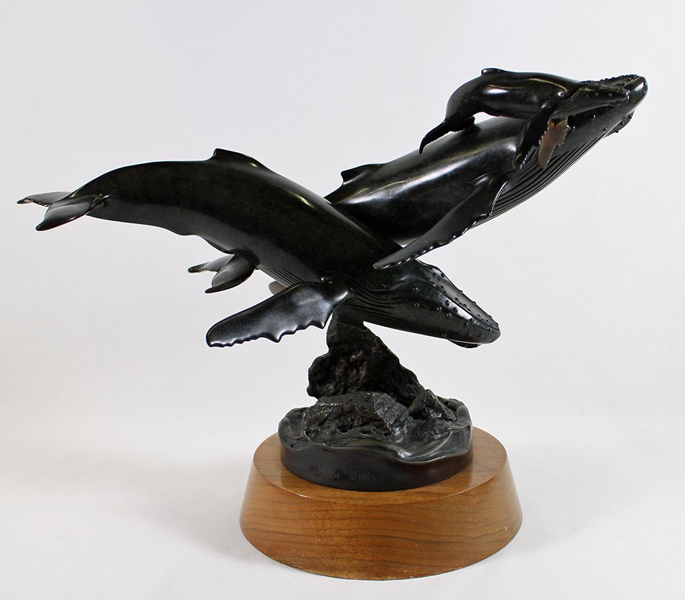 RANDY PUCKETT HUMPBACK WHALE BRONZE SCULPTURE: Humpback whale family set in bronze by sculptor Randy Puckett. Numbered 34/350 and dated 1993. Measures 16" x 12" and stands on a rotating wood base.