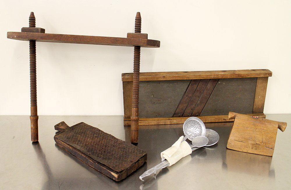 CARVED PRIMITAVE WOOD COLLECTION: Spindle shelf, folk art wood bell, graters, aluminum hand forged utensils