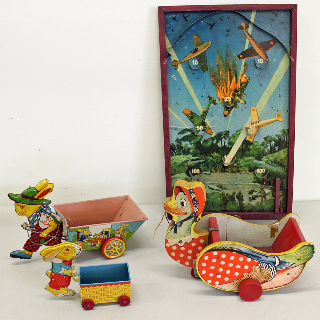 VINTAGE PULL TOYS & MILITARY PIN BALL GAME: (2) J. Chein rabbits, one pulling cart and one pushing cart, wood duck, and Durable military plane pinball game.