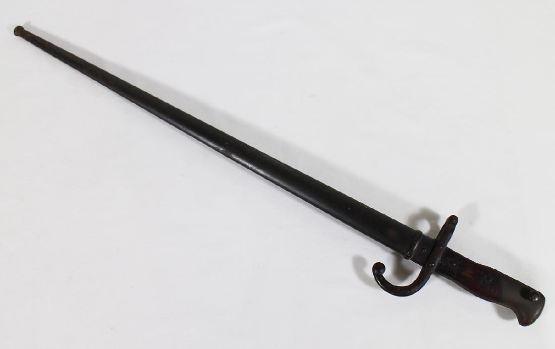 1877 FRENCH BAYONET: Military bayonet. Hallmarked on handle & blade. 26" long w/ scabbard.