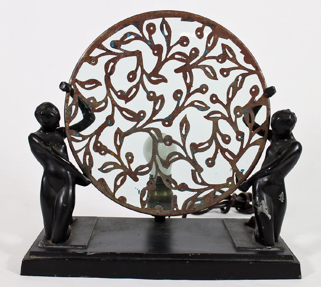FRANKART ART DECO FIGURAL LAMP: Frankart Art Deco figural map with two nude females holding round metal disk with glass insert. 12.75" wide 12.5" tall.