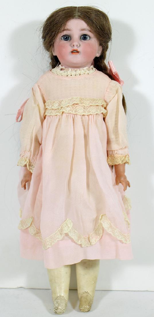 SIMON & HALBIG 1260 BISQUE DOLL: Antique bisque head Simon & Halbig shoulder head doll with blue sleepy eyes, brown human hair wig, open mouth with teeth and a jointed composition arms. 15" tall. The back of he head is marked S & H D