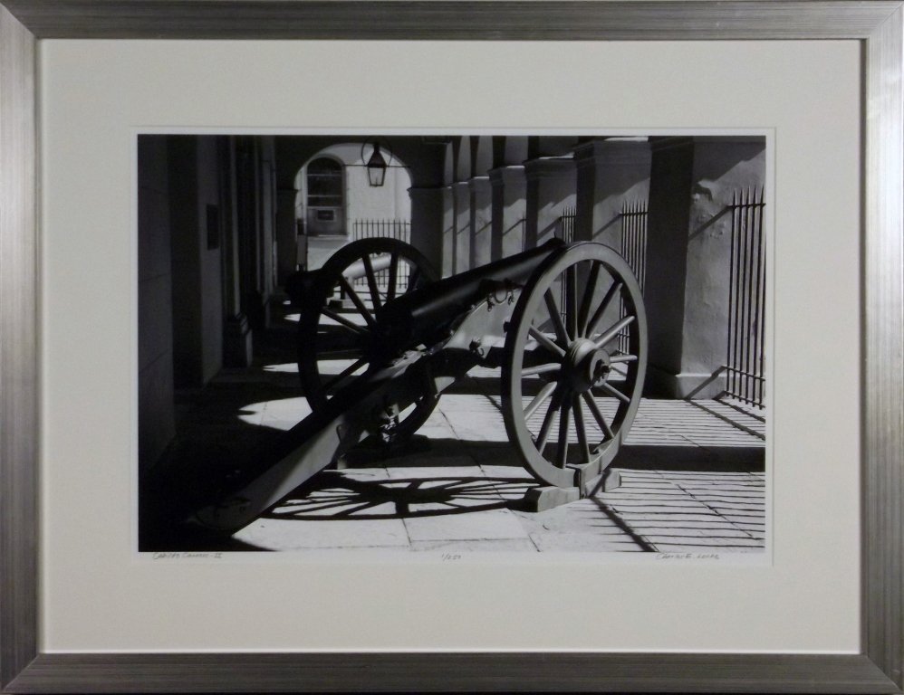 LECHE PHOTOGRAPH: CHARLES E. LECHE. CABILDO CANNONS - 2. Photograph of cannon. Black, white. Signed. Numbered 1/250. 18 x 24 in. Framed. Donated by Charles E. Leche. On-air Title: Leche Photograph. Estimated Value: $22