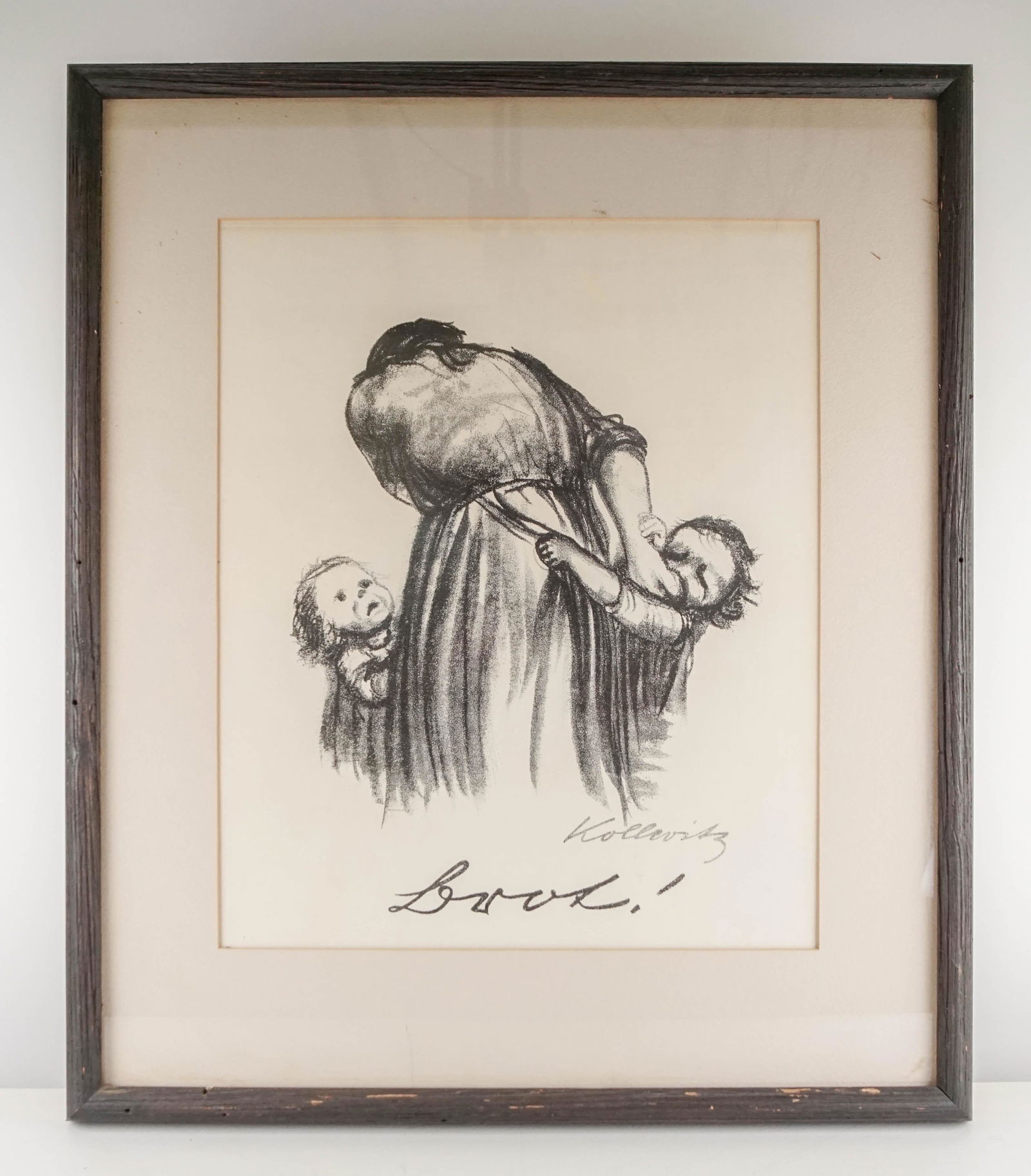 Kollwitz, Kathe: 112. Kollwitz, Kathe.Brot! Lithograph of a mother and 2 children. Image size about 15 x 11 inches on 21 x 17-1/2 inch paper mounted to board, in glass-fronted frame; sunned. Np, nd [250/350].. --Klips