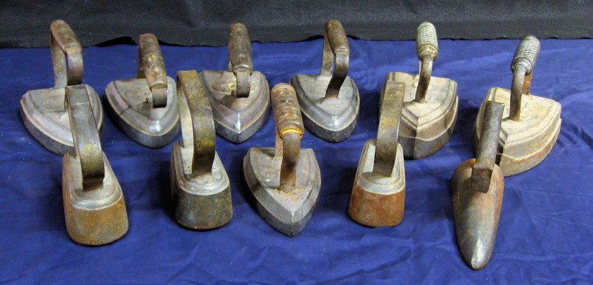 Flat Iron Collection: Group of 11 sad irons. Various sizes and styles; varying wear, occasional rust spots, though generally sound. Includes: Two inclined handle irons by E. Butts of Providence, R. I * Three shirt and coll
