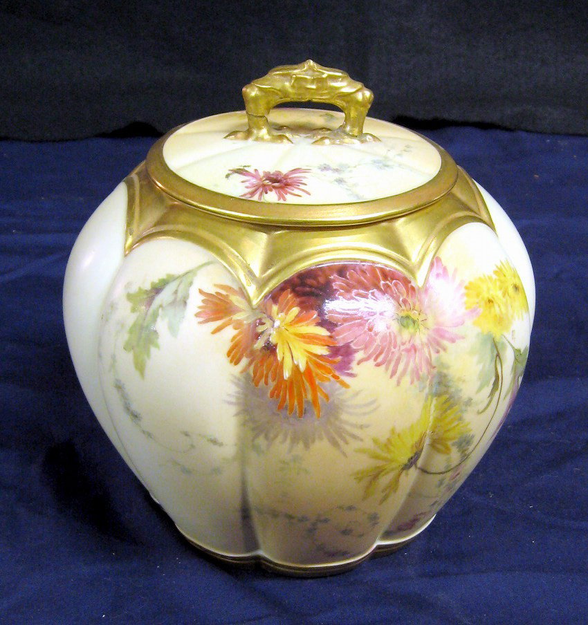 Royal Worcester Jar: A Royal Worcester blush-ivory-ground lobed oviform jar and cover, painted and gilt with loose sprays of wild flowers below gilt sections, shape 1412, puce marks, date codes for 1894 and signed "BT". L