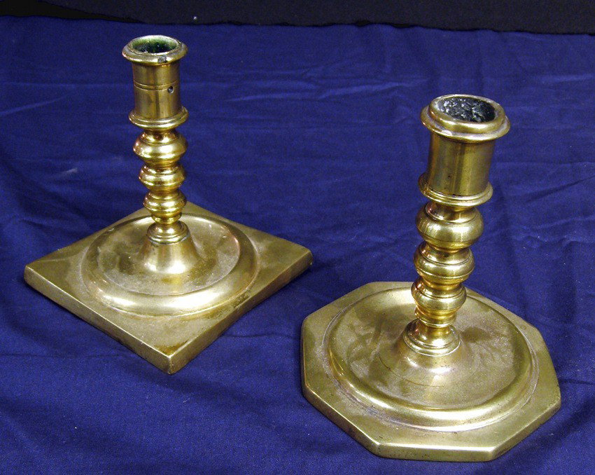 Seventeenth Century Candlesticks: 6 inch high, square saucer base * 6 inch high octagonal saucer base. Together two brass candlesticks, possibly of Spanish origin; moderate wear. Continental , 1690s