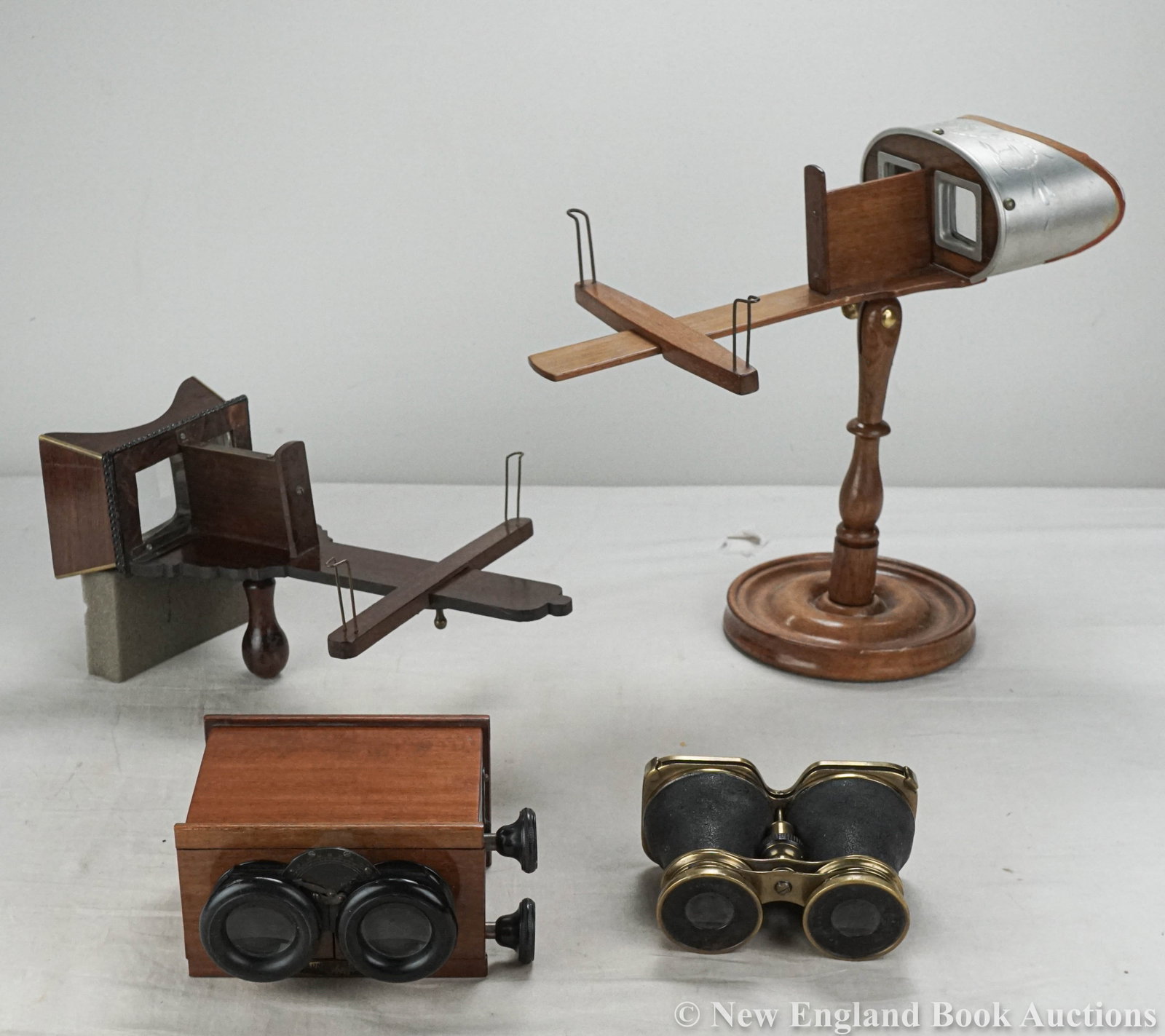 Stereoscopes: 157. Stereoscopes. Group of 4, as listed below. Various sizes and formats; moderate wear. Vp, 1890s-1900s [80/120] Busch brass fitted Diascop * Unis France walnut box viewer * Brass and wood hand held