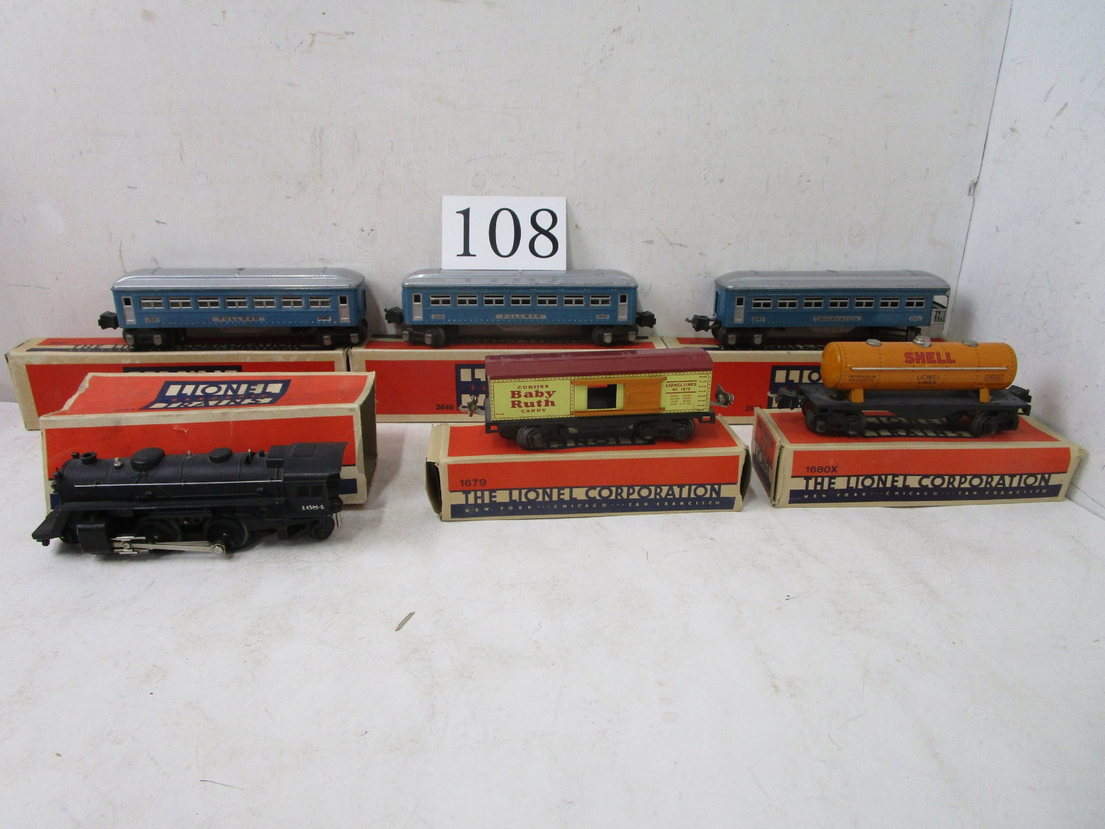 Lionel Trains: Lionel with boxes; #2640 blue w/silver roof passenger car, #2641 observation car, #1684 black engine, #1684 box car, #1680 X tank car, #1682 caboose