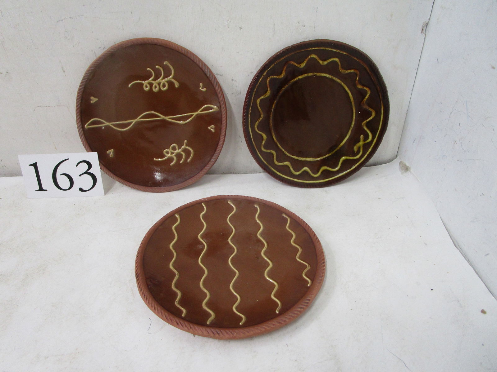 Redware Pottery: (3) Old Sturbridge Village slip decorated 9" diameter redware plates