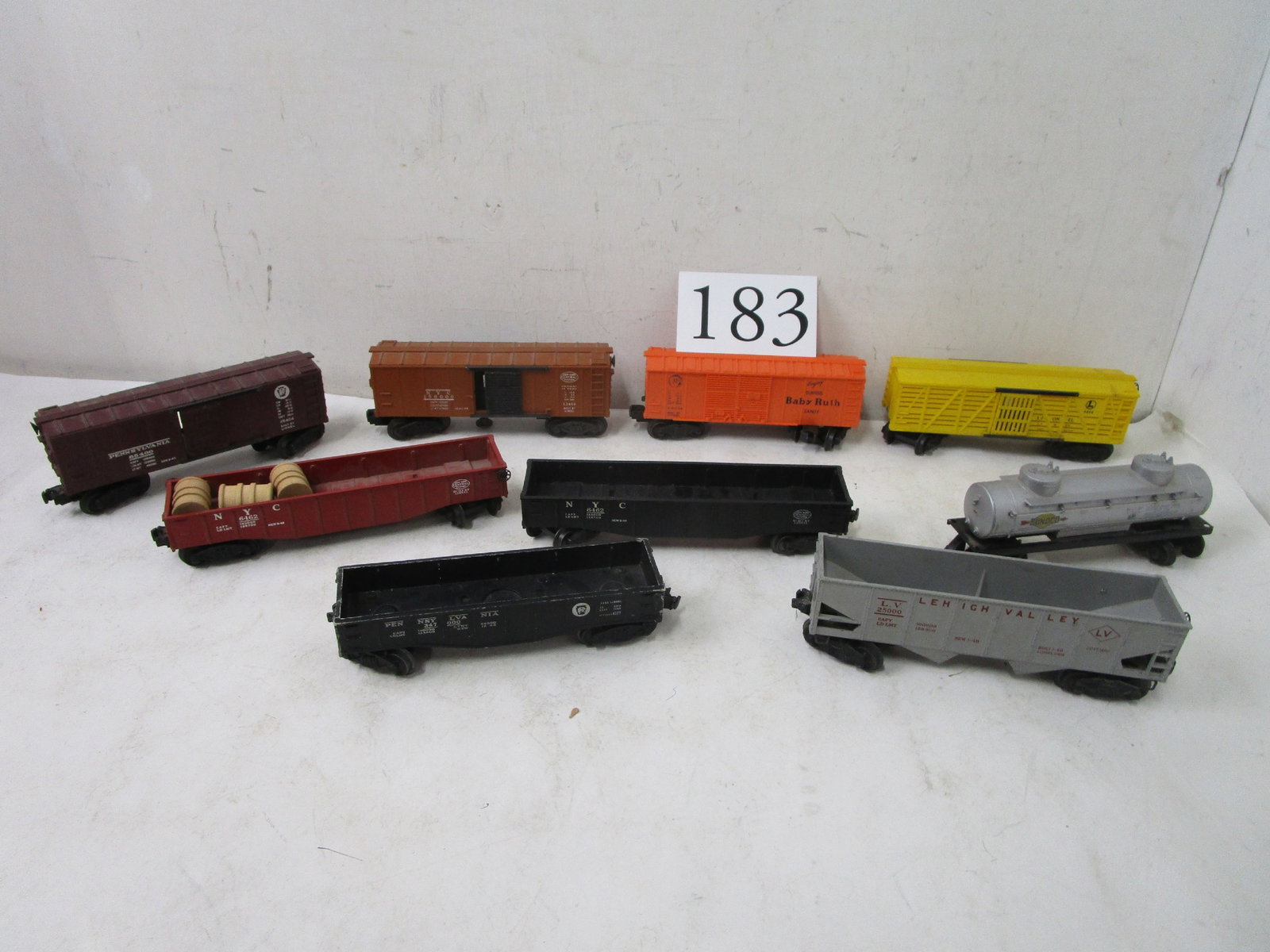 Train: #X6034 orange Baby Ruth box car, #X3464 N.Y. Central box car, #6656 yellow cattle car, #X6454 Penn. box car, #6462 N.Y. Central black gondola, #6465 gray Sunoco tanker, #64662 N.Y.C. barrel car, #6456