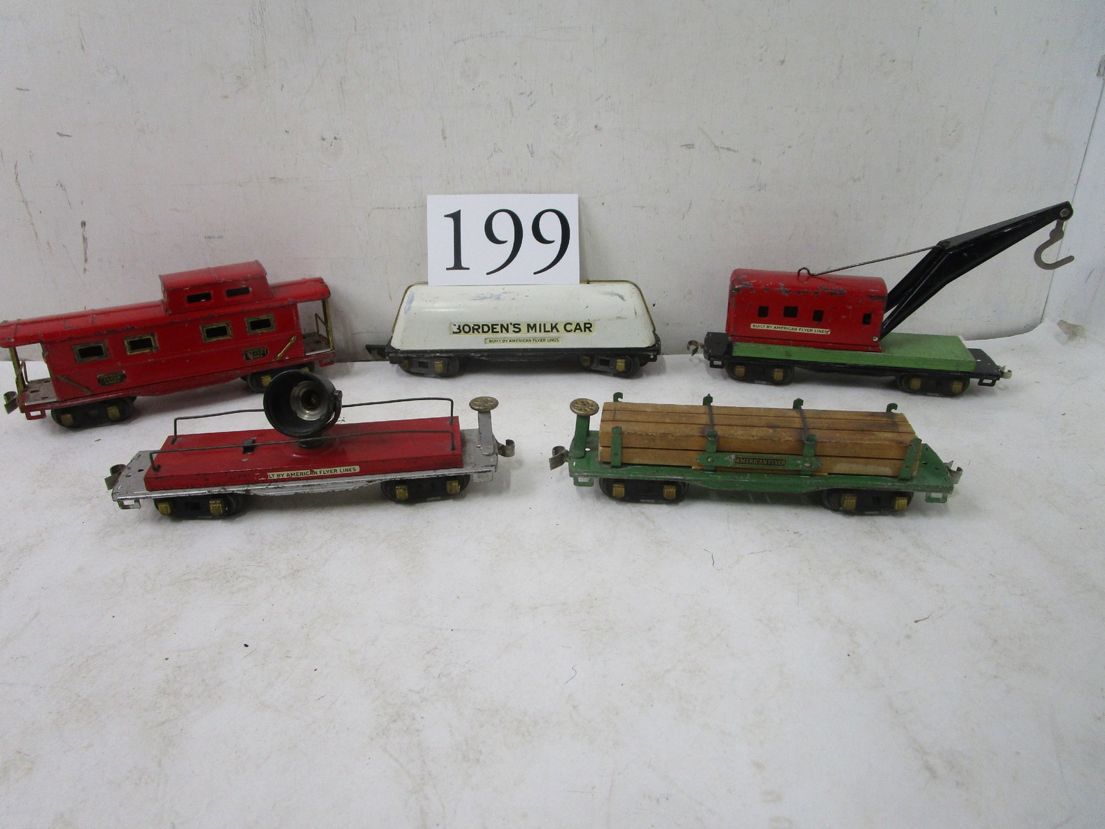 American Flyer: American Flyer sheet metal Knuckle coupler 1938 #3025 crane car, #3046 lumber car, #415 flood light, #411 caboose, Borden's milk car