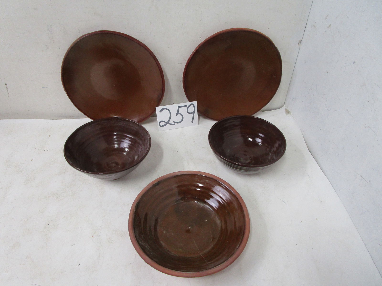 Redware Pottery: (2) 11.25" Old Sturbridge Village redware plates, (2) 8" bowls