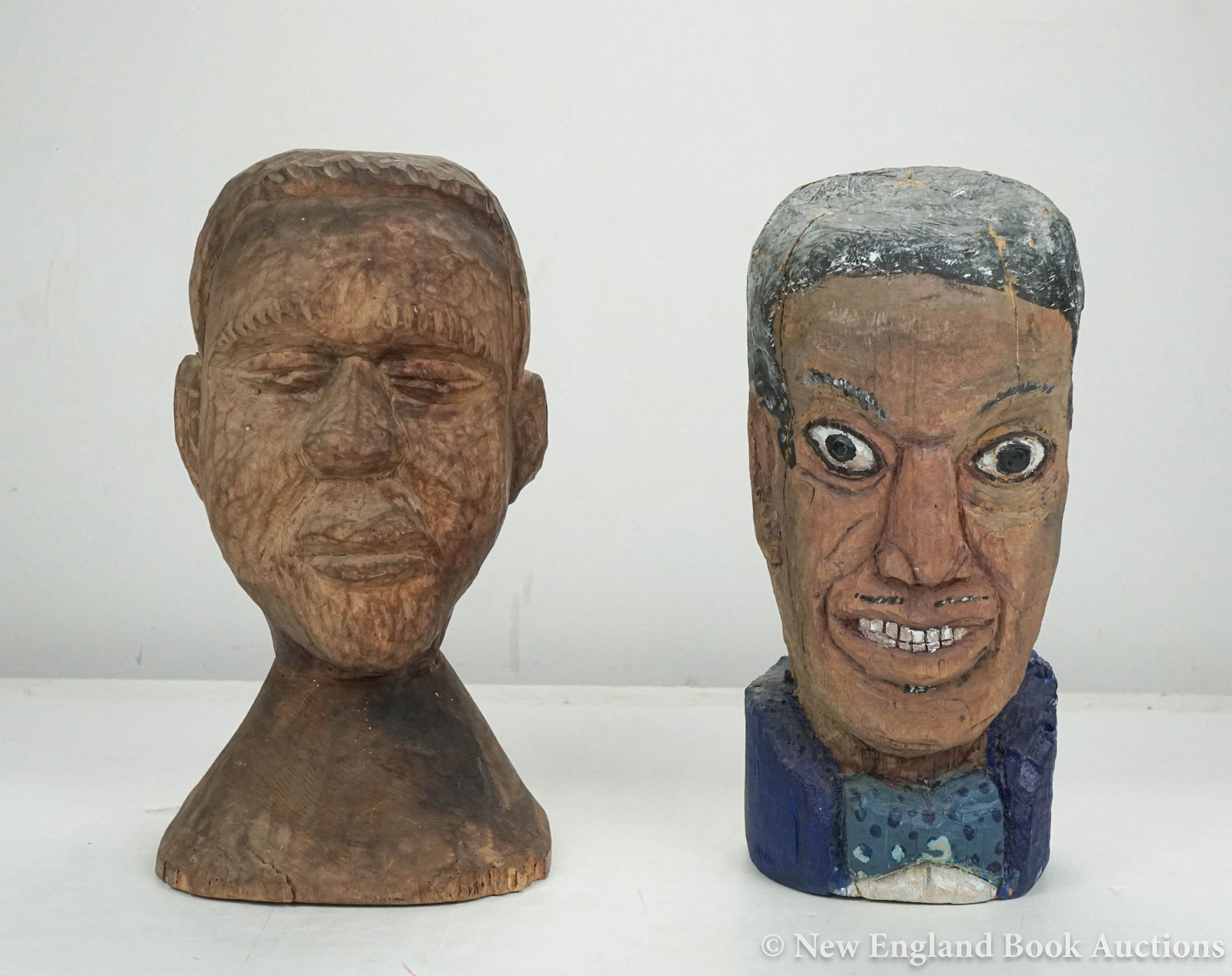 Sculpture: 4. Sculpture. Two hand carved wood busts. Each about 9 inches high, one painted (a few cracks); generally sound. American, 20th-century [80/120] Painted bust is titled Huddie Ledbetter