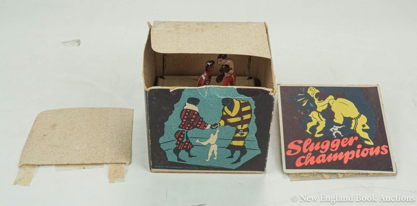 Mechanical Toy: 9. Mechanical Toy. Slugger Champions. 3-1/2 inch square base, original key, original box (top flaps detached); moderate wear, some rust in base corner. "Zone Germany", 1940s [75/100]