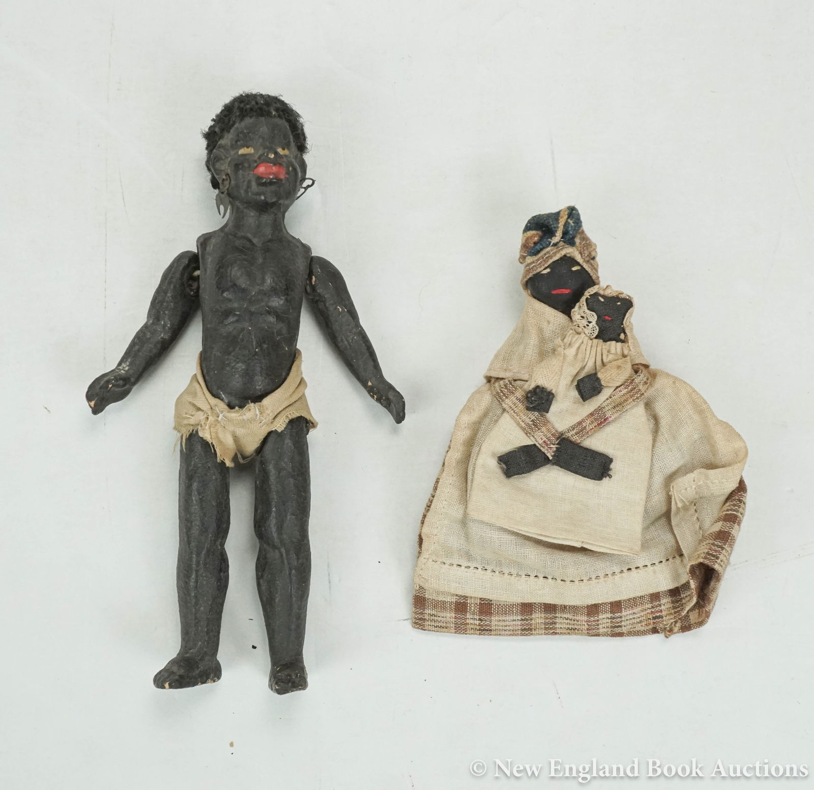 Black Dolls: 33. Black Dolls. Fired clay (?) articulated black doll with contemporary cloth and original hair * Rag doll of black mother and child. 6 or 5 inches in height respectively; first with some chipping. 