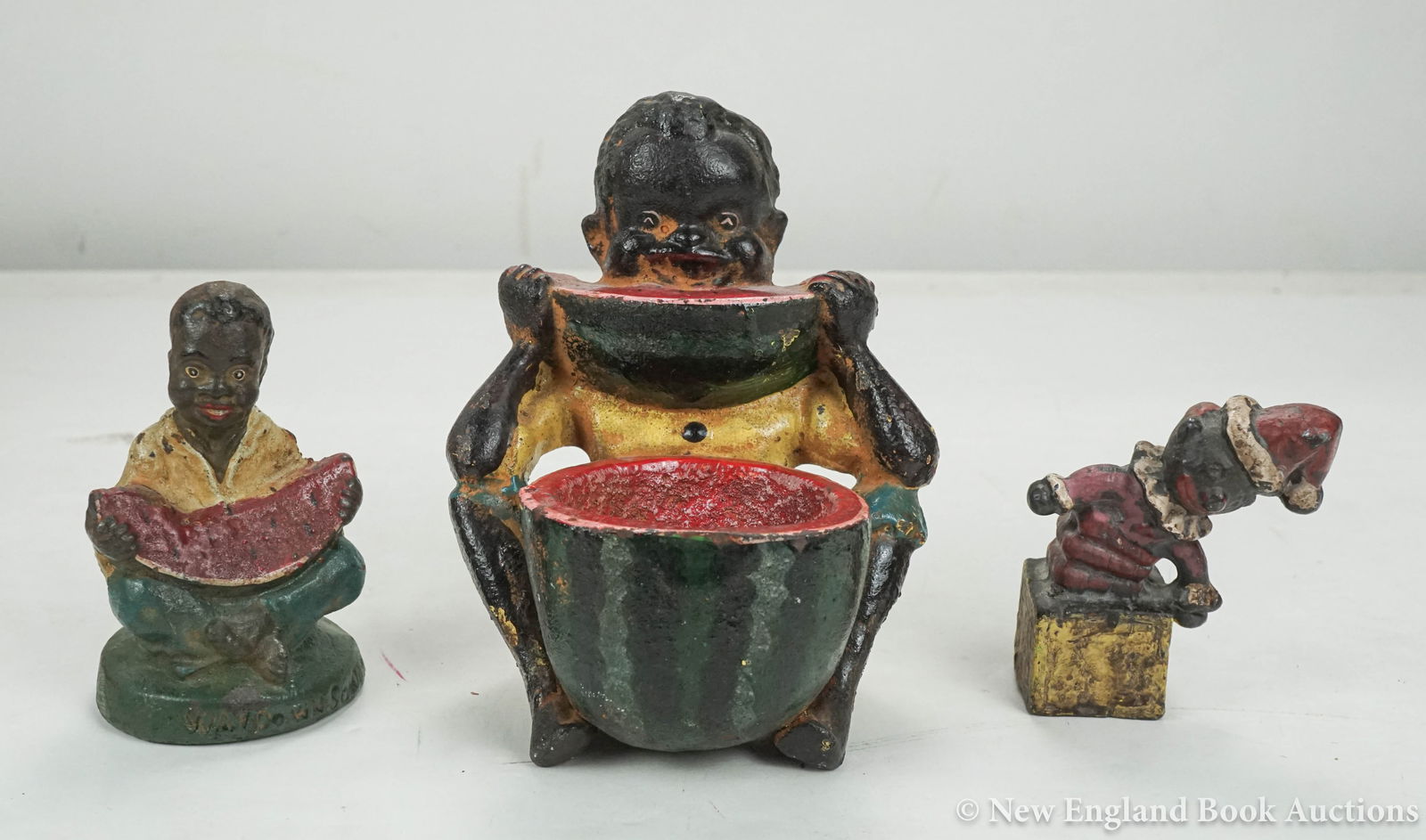 Cast Iron Paperweights: 36. Cast Iron Paperweights. Group of 3, as listed below. Various sizes; original paint (chipped); moderate wear. American, nd [200/300] Boy Eating Watermelon, seated with watermelon ashtray (?). 5