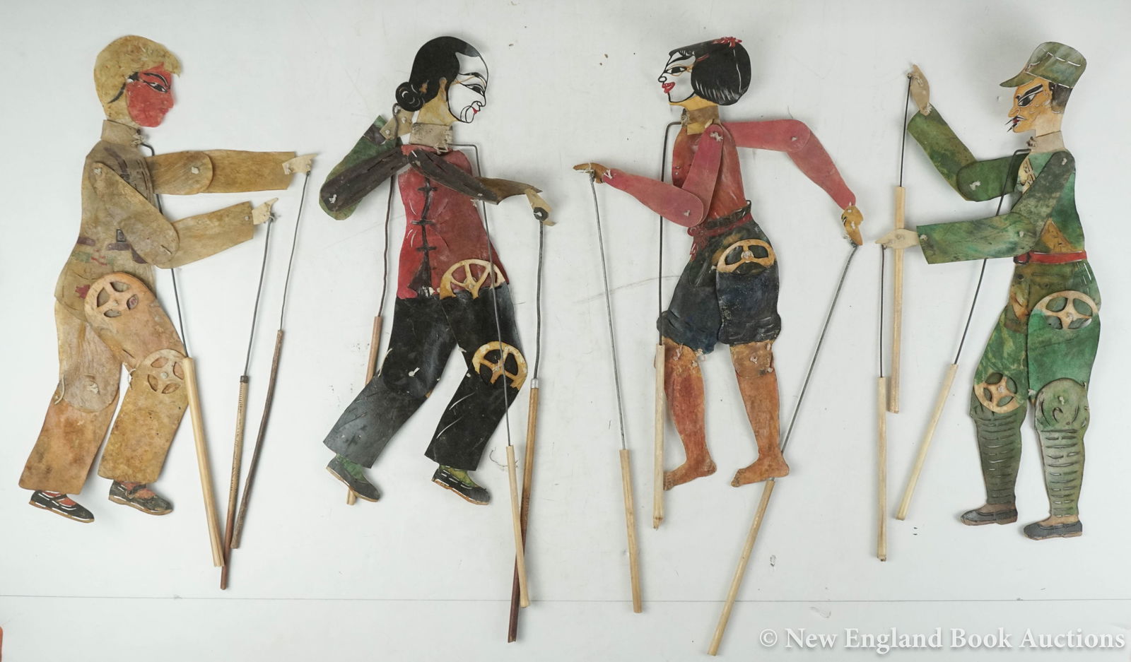 Chinese Shadow Puppets: 196. Chinese Shadow Puppets. Collection of over 50 hand-painted (5 color?) cut leather articulated puppets with metal and wooden handles. Most around 16 inches in height; varying wear, some parts
