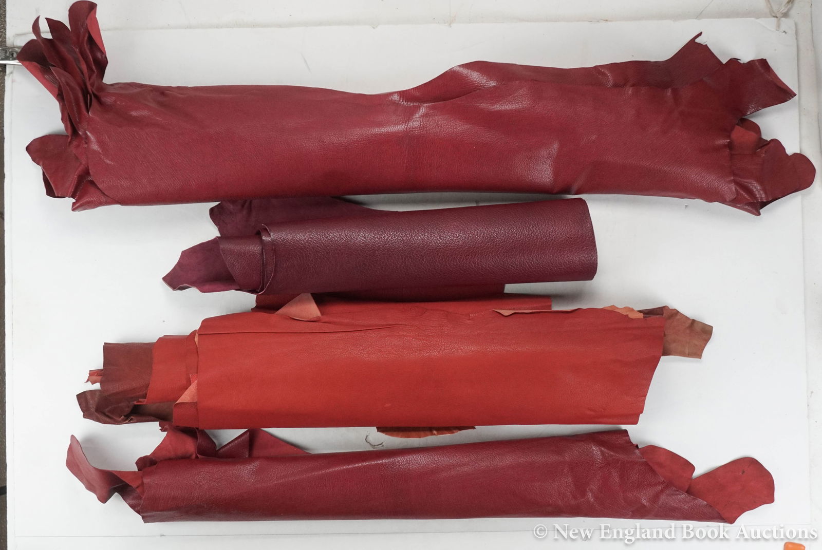 Bookbinding Leather: 206. Bookbinding Leather. Group of 13 skins + several smaller pieces. Mostly dyed red. Various sizes; light wear, some clipped. Np, nd [200/300]