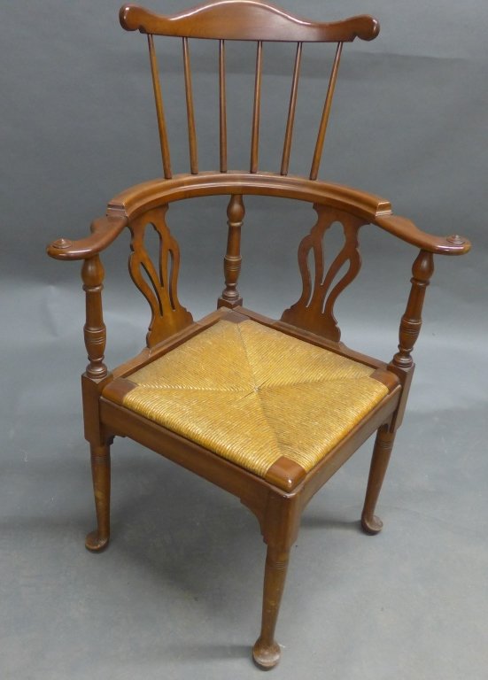 Corner Chair with Rush Seat: Corner armchair with carved wood frame and rush seat. Height: 43 3/4", Width: 30", Depth: 26 1/2"(seating, seat, furniture, accent piece)STERLING ASSOCIATES STRIVES TO PROVIDE ACCURATE, OBJECTIVE, & F