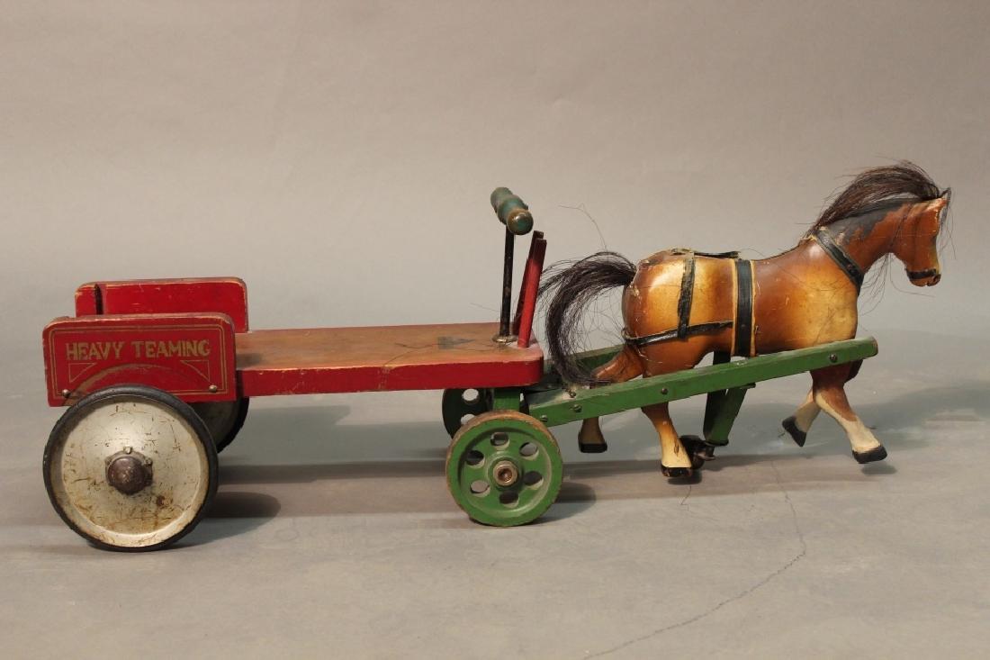 "Drive Em" Horse & Wagon: "Drive Em" Horse & Wagon by J. ACRIM Manufacturing. Vintage carved and painted wood toy of horse and cart. Maker's label on cart and horse. Appears to be missing horse strap. Wear and imperfections. H