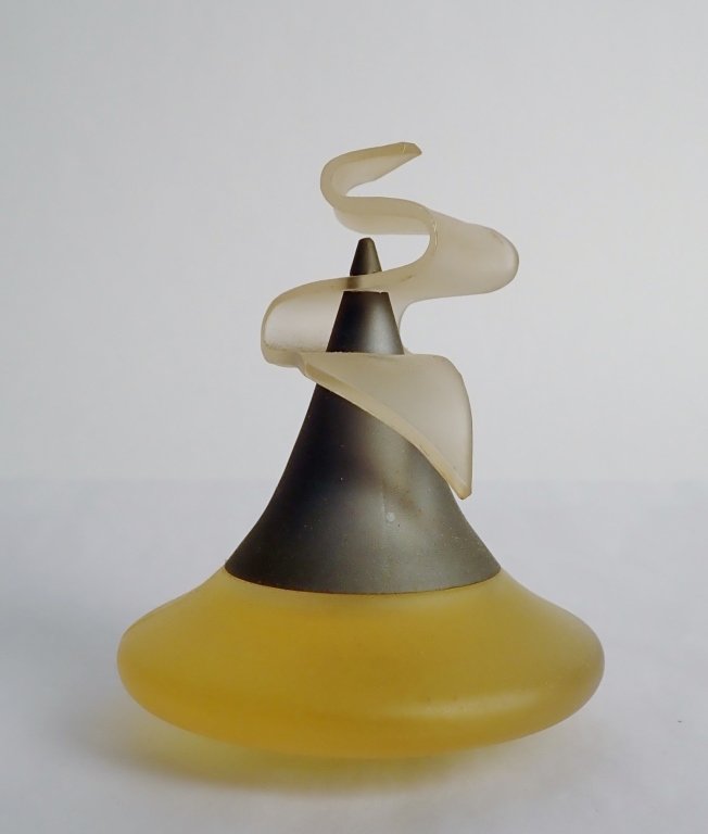 Vintage Romeo di Gigli Perfume Bottle: From the Estate of Marty Prail. Romeo di Gigli vintage perfume.Perfume Bottle with abstract Frosted Ribbon Celluloid Cap. Height: 3 3/4"; Width: 3"; Depth: 3". **Please check with shippers prior to bi