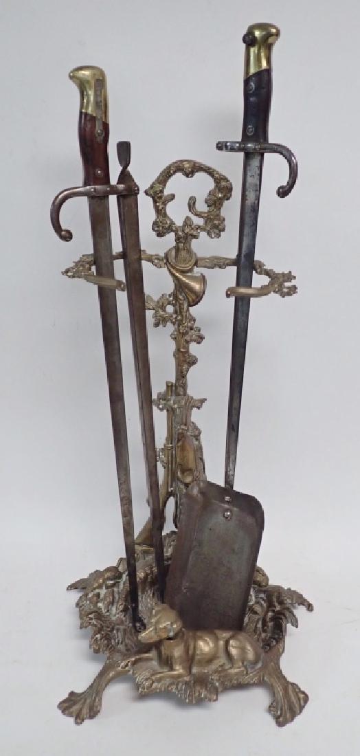 Bronze Hunting Fireplace Stand with Bayonet Tools: Bronze Fireplace Stand with Dog and Hunting Motif. The stand features a hunting dog with a head that turns, lying down at the front of the base. Behind him a hunting rifle leans upon a tree trunk, and