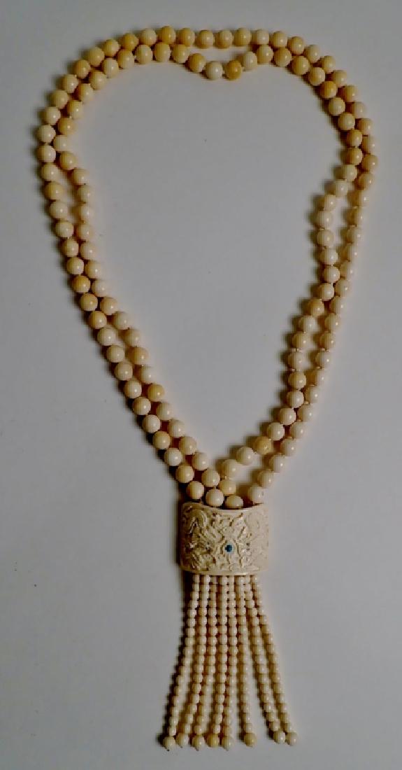Carved Asian Dragon Necklace: From the Estate of Joyce Dankoff. Bead necklace with carved dragon design. Possible bone. length 21 1/2". (jewelry, fashion, accessory, design) STERLING ASSOCIATES STRIVES TO PROVIDE ACCURATE, OBJECTI