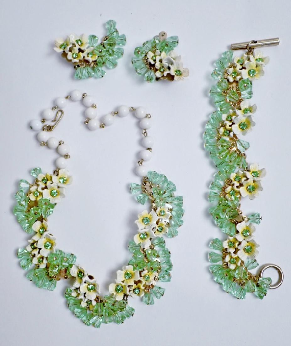 Crystal and Floral Fashion Jewelry Set: Green crystals accent the white and yellow flowers that make up this set of necklace, bracelet and a pair of clip-on earrings. Earrings are marked Pat Pend. No other noticeable makers marks. Braclete 