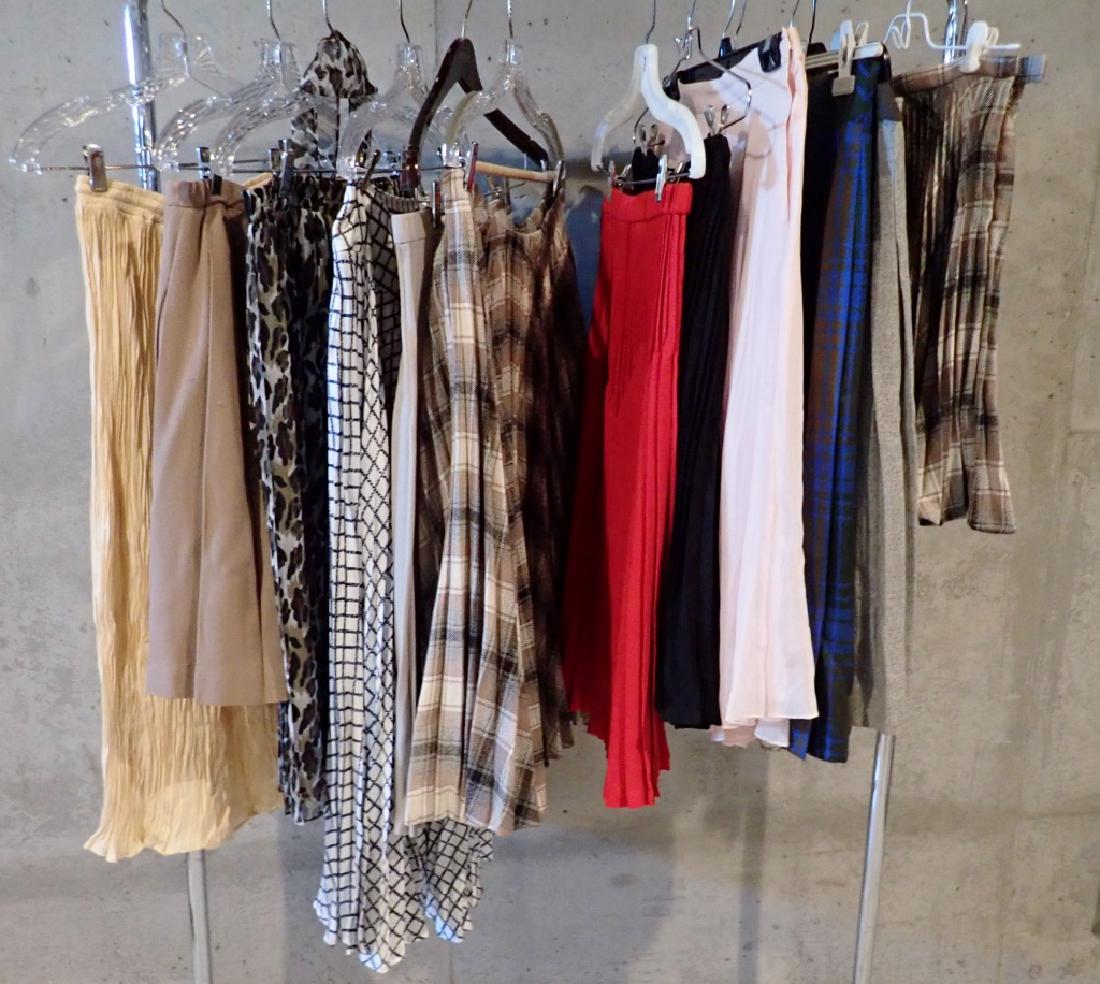 Collection of Vintage Ladies Pleated Skirts: From the Estate of Joyce Dankoff. 12 assorted pleated skirts and one pair of culottes. Features various styles, sizes, lengths and fabrics. Labels include: Back Street, Betty Hanson, Saks Fifth Ave, P
