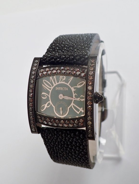 Invicta Diamond Black Stingray Skin Watch: From the Estate of Joyce Dankoff. Black Invicta ladies Watch with stingray band.Back marked in part: Stainless Steel / Water Resistant 3 ATM / Model No. 4383. Length: 9 1/2". (Jewelry, fashion, design