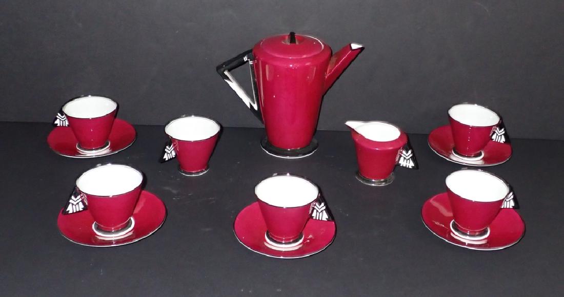 Art Deco Shelley Vogue Chevron Handle Tea Set: Maroon, black & white Art Deco lidded tea pot, creamer, tea cups and saucers. Shelley Mode Vogue Pattern with chevron handles. Includes 5 saucers, 6 tea cups creamer and tea pot with lid. Makers marks
