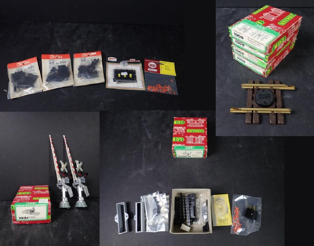 Selection of Model Train Accessories: Lot includes: - Model Train Accessories: Couplers & Connectors: 3 Kadee No. 830 Body Mounted Couplers Atlas Model Railroad Co., Inc. #205 Connector LGB Press Cable Connectors approx. 50 pcs. - LGB 103