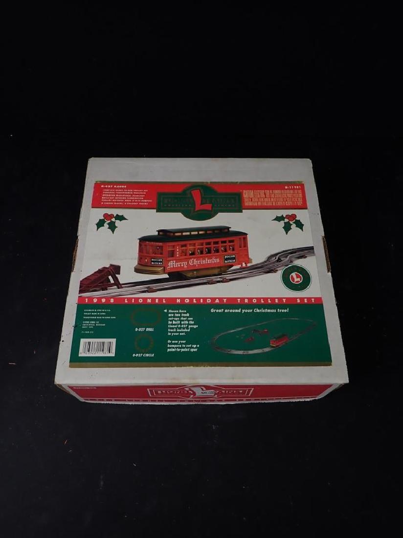 Lionel 1998 Holiday Trolley Set: Lionel 1998 Holiday Trolley Set with original box. Height: 4"; Width: 12"; Depth: 12" (model train, train, lionel, germany, postwar) STERLING ASSOCIATES STRIVES TO PROVIDE ACCURATE, OBJECTIVE, & FAIR
