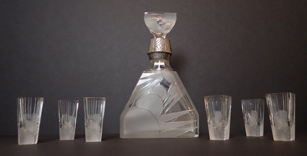 Art Nouveau Decanter & Shot Glass Set: Period glass and silver (untested) decanter with an art nouveau design with six matching shot glasses.One shot glass appears to have an been filed down.Decanter height including stopper: 9 3/4"; Width
