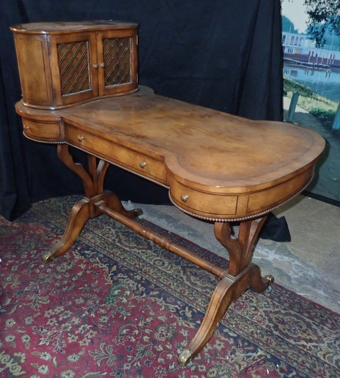 Unusually Shaped Vintage Desk: This desk features an unusual dog bone shaped top with raised compartment to one side. Compartment has double door on the front and a single shelf on the back. Three drawers on one side. False drawers