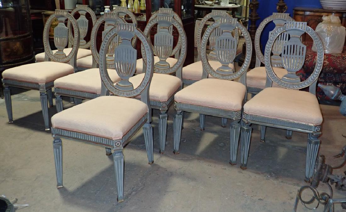 Set of 11 Louis XVI Shield Back, Urn Form Chairs: Eleven carved & painted wood chairs with upholstered seats. Louis XVI style. Chairs feature urn shape shield back. Imperfections. Staining. Height: 39"; Width: 19 1/2"; Depth: 18 1/2". Seat height: 19