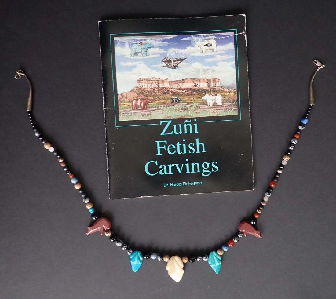 Carved Zuni Navajo Fetish Necklace: Carved Native American fetish animal and bead necklace with frogs & bears. Includes booklet shown. Features Turquoise, moonstone, onyx, carnelian, lapis, jasper, hematite and more. Length: 26 1/2". (F