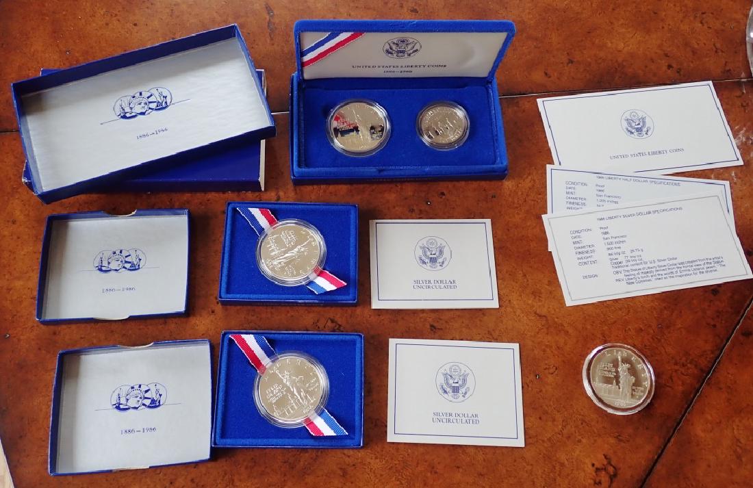 Five US Mint Silver Liberty Coins: Liberty Coin collection includes: (2) 1986-P Uncirculated Liberty 90% Silver Dollar Coins. with Box & COA s. (1) 1986 S Statue of Liberty two coin set Statue of Liberty silver dollar and a Liberty hal