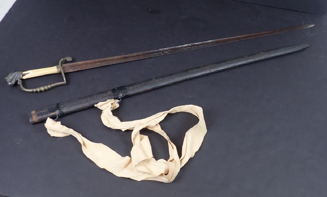 Sword with bone handle & leather scabbard: Antique sword with scabbard. Natural material handle is damaged. Etched blade. Total length: 37"; Length of blade: 31 1/4". Imperfections. (weapon, sheath, military) STERLING ASSOCIATES STRIVES TO PRO